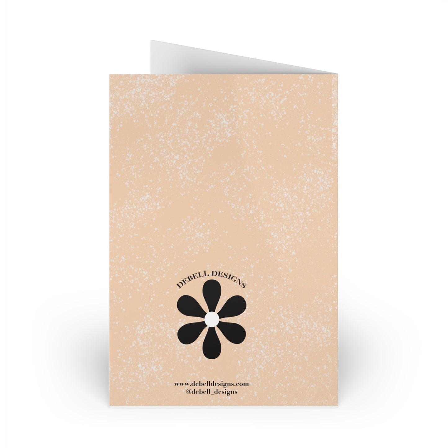 {"altText": "Open greeting card standing vertically, back view. Beige with brown speckles, a black flower logo, and "DEBELL DESIGNS" text."}