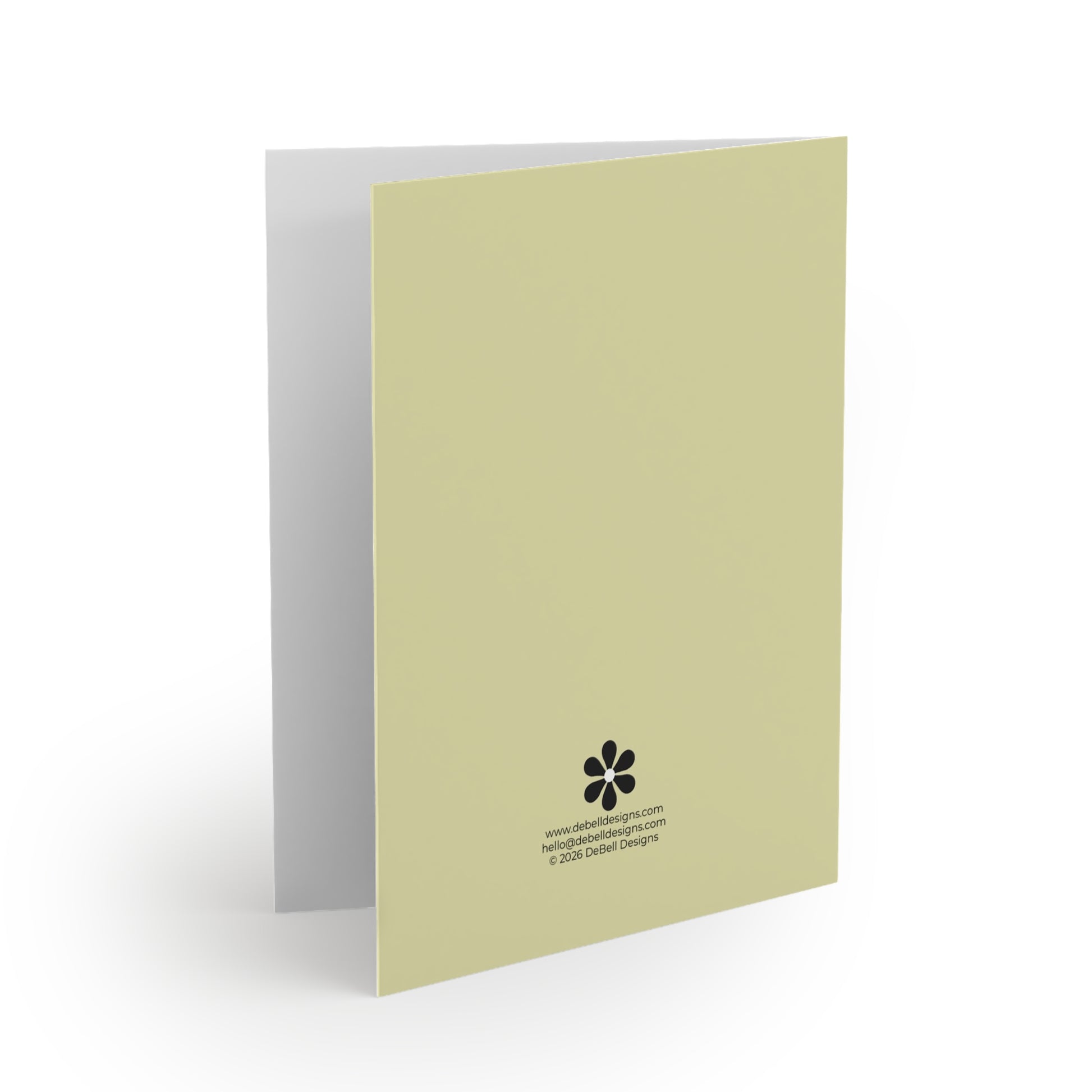 Open greeting card standing upright, angled right, with a light chartreuse back side and white interior, on a white surface.