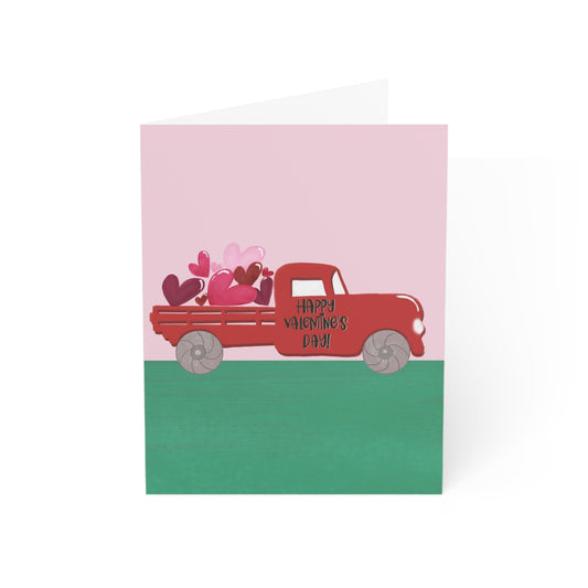 Valentine's Day card with a red truck and hearts on a pink and green background