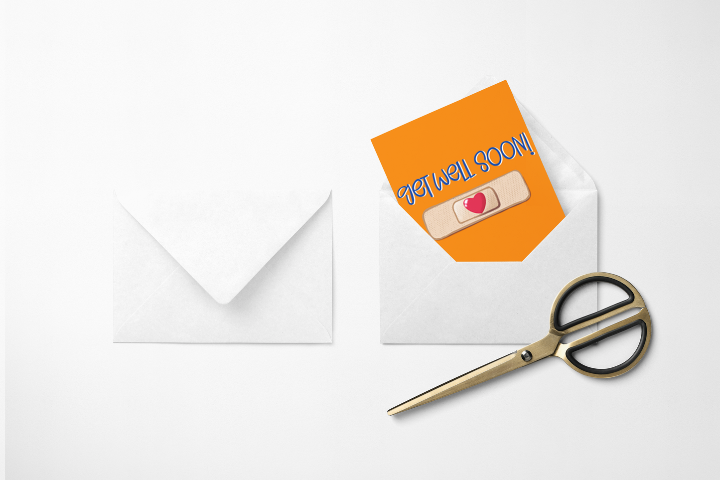 “Two white envelopes on a white background, one opened showing an orange card that says "get well SOON!" and has a band-aid with a red heart, next to gold scissors.”
