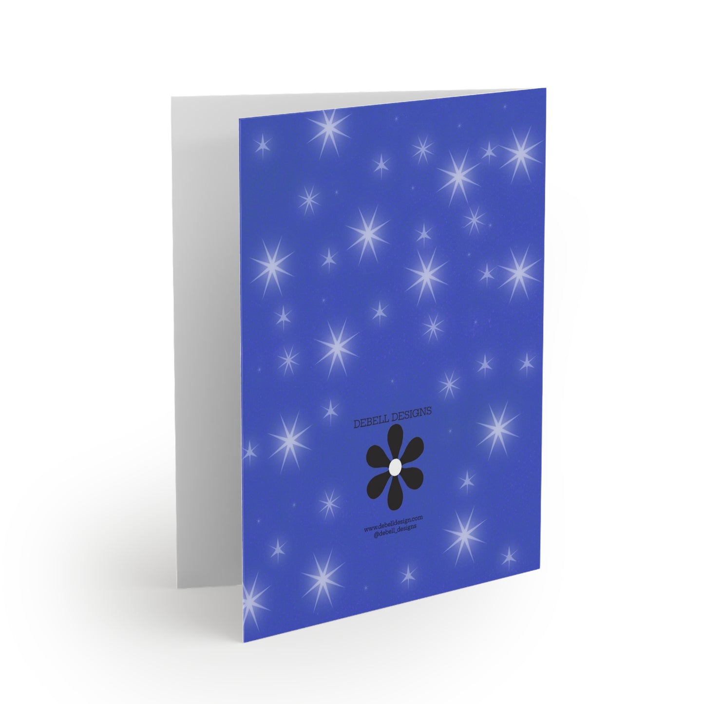 “Open greeting card with the front cover facing right. It has a blue field with white starbursts of different sizes, a black flower icon, and small print.”