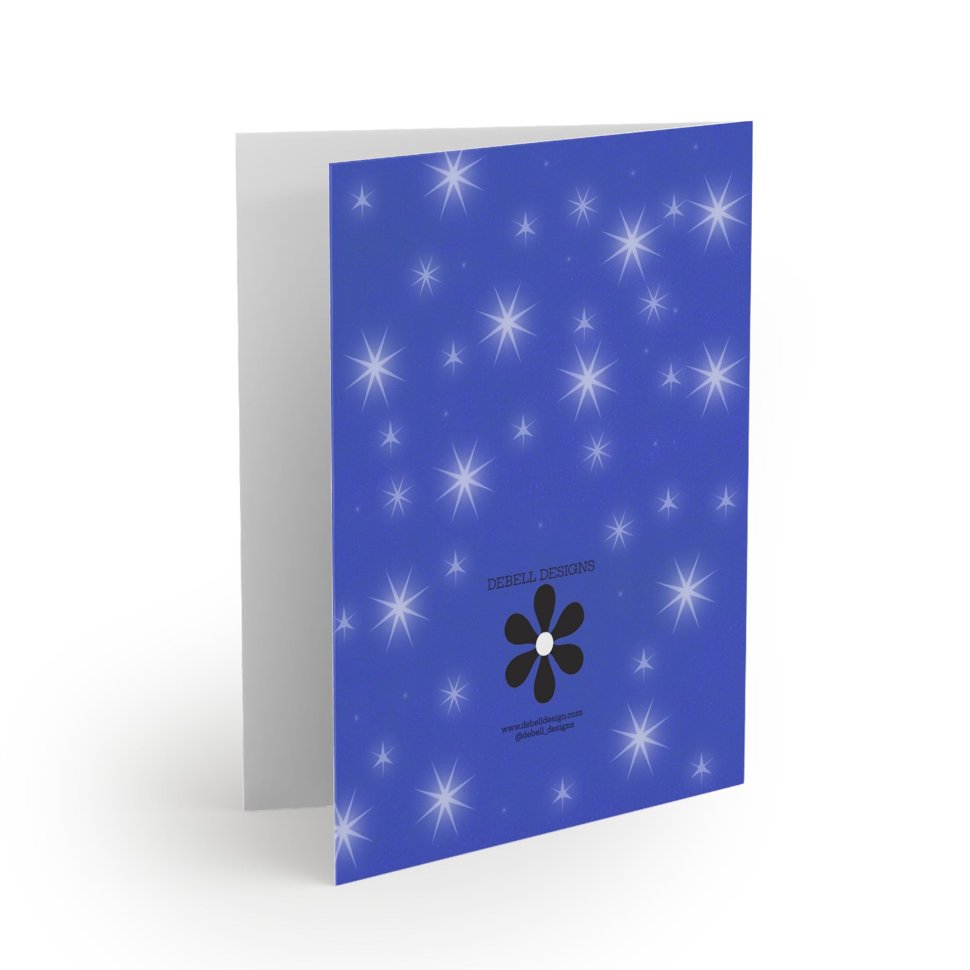 “Open greeting card with the front cover facing right. It has a blue field with white starbursts of different sizes, a black flower icon, and small print.”