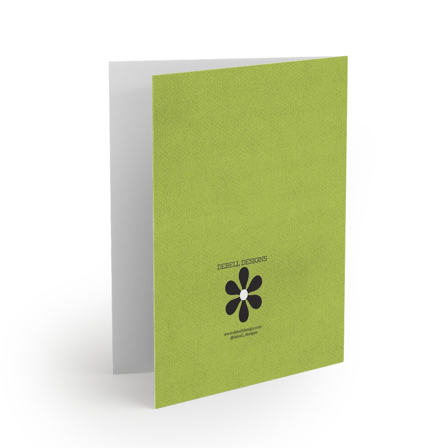 {"altText": "Open card on white background, angled right, showing the lime green back cover with "DEBELL DESIGNS" and a black flower logo, plus website and social media handle."}

