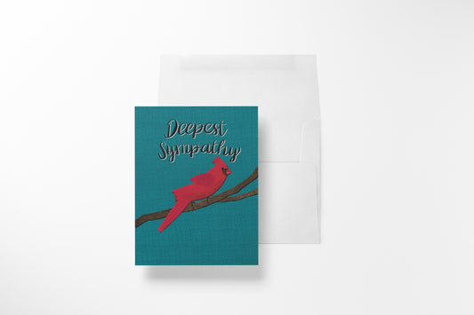 A greeting card with a teal background, a red cardinal perched on a branch, and the words 'Deepest Sympathy' in white script, shown with a white envelope behind it on a light gray background.